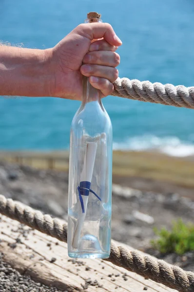 Bottle with a message in the hand — Stock Photo, Image