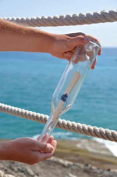 Bottle with a message in the hand — Stock Photo, Image