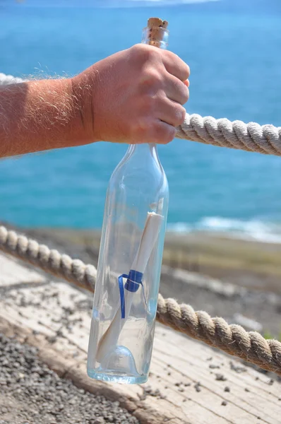 Bottle with a message in the hand — Stock Photo, Image