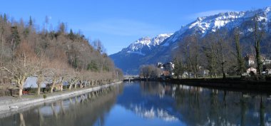 View to Aare river and snowy Alps. Interlaken, Switzerland clipart