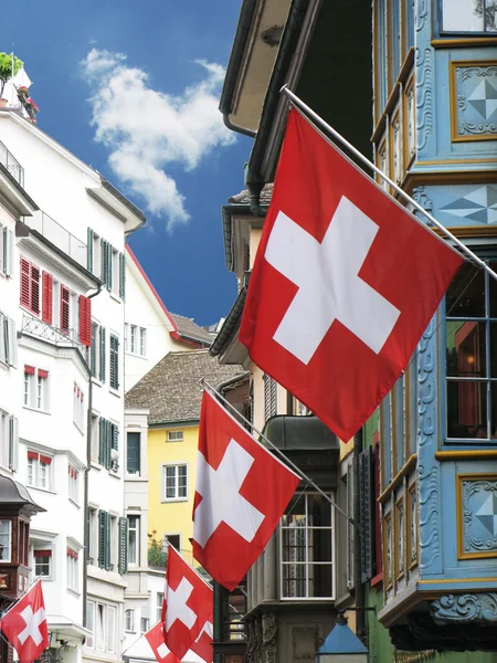 Old street in Zurich decorated with flags for the Swiss National — Stock Photo, Image