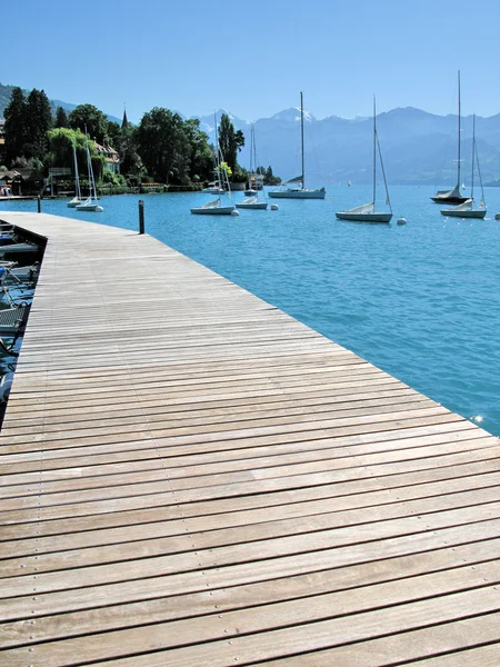 Wooden pier against lake Thun and Alps. Switzerland — Stock Photo, Image