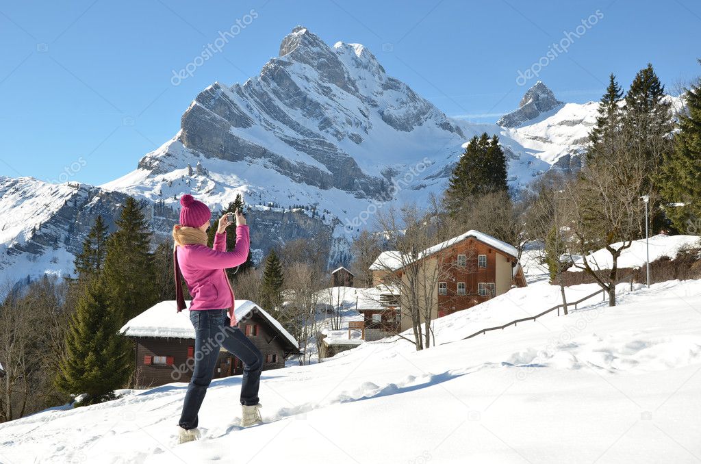 Girl taking a photo in the Swiss Alps