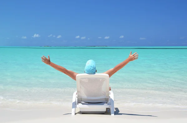 A young man sunbathing on the beach of Exuma, Bahamas — Stock Photo, Image