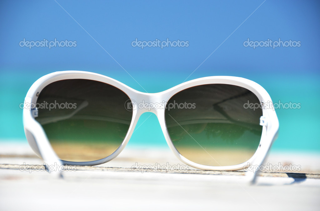 Sunglasses against tropical ocean