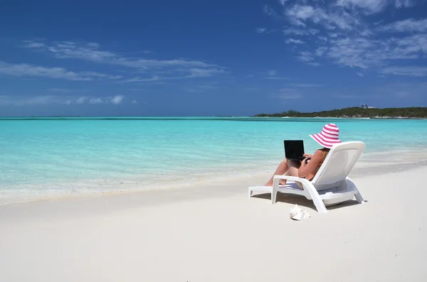 Gadis dengan laptop di pantai tropis. Exuma, Bahama — Stok Foto