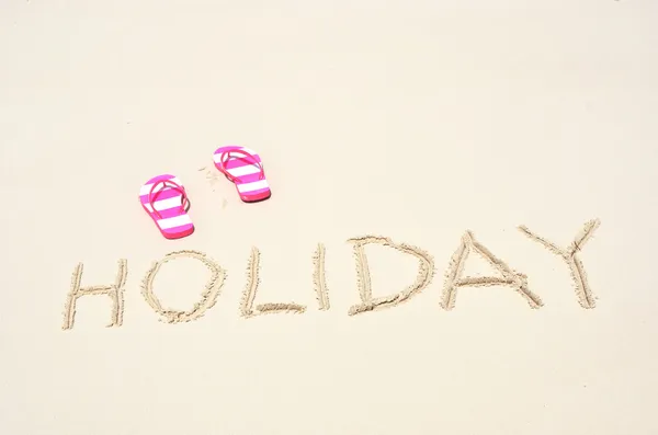 HOLIDAY writing on the sandy beach — Stock Photo, Image