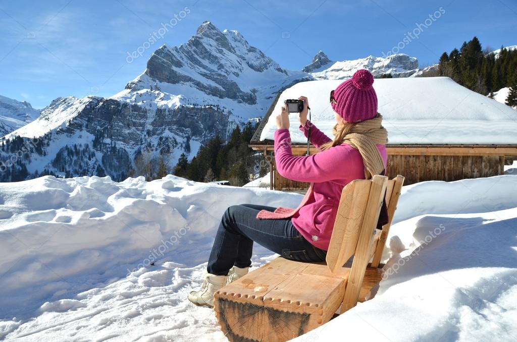 Girl taking a photo in the Swiss Alps
