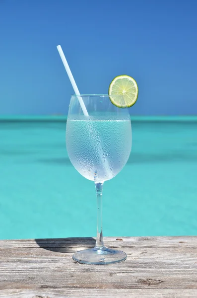 Glass of water against blue sky — Stock Photo, Image