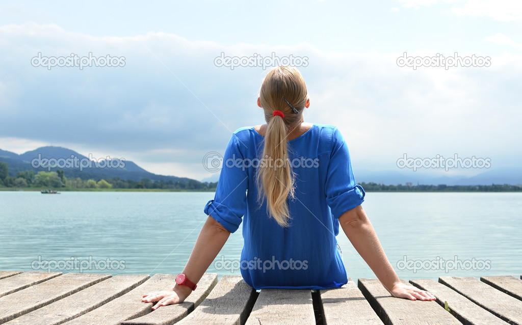 Girl on the wooden jetty. Switzerland