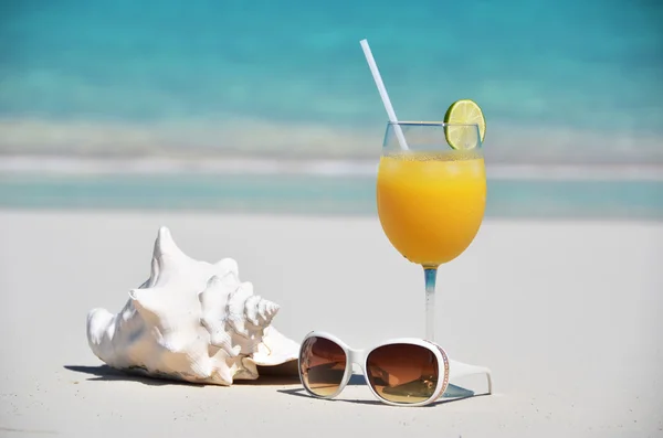 Jugo de naranja y gafas de sol en la playa. Exuma, Bahamas — Foto de Stock