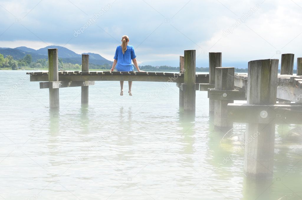 Girl on the wooden jetty. Switzerland