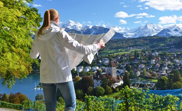 Girl looking to the map. Switzerland — Stock Photo, Image