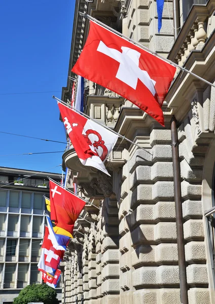 Old street in Zurich decorated with flags — Stock Photo, Image