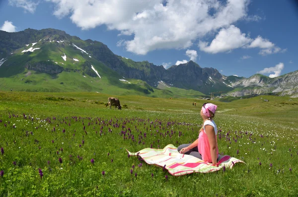 Girl in an Alpine meadow. Stock Picture