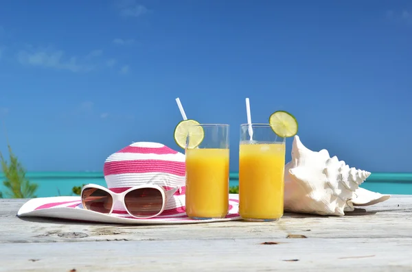 Okulary przeciwsłoneczne, kapelusz i sok pomarańczowy — Zdjęcie stockowe