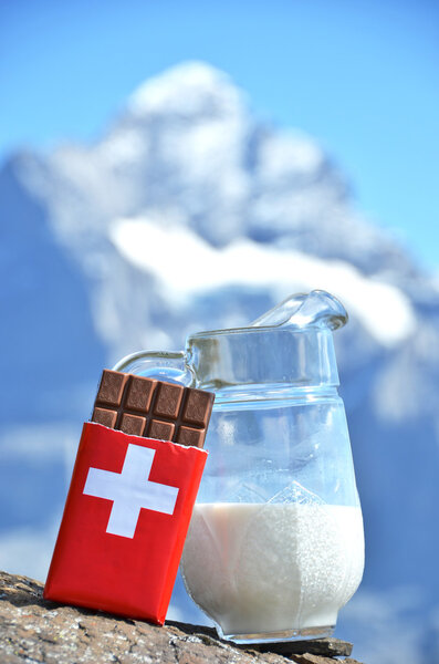 Chocolate and milk against mountain peak