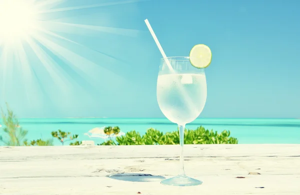 Glass of water on the tropical beach — Stock Photo, Image