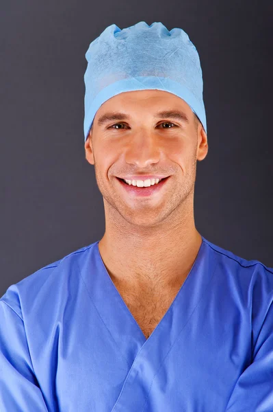 青いシャツを着て暗い背景の上の医者 — ストック写真