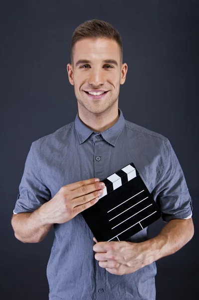 Man with movie clap over dark background — Stock Photo, Image