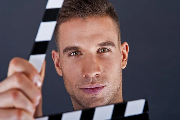 Man with movie clap over dark background — Stock Photo, Image