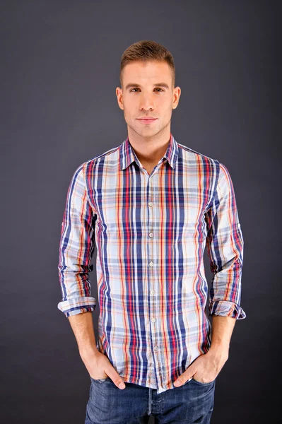 Man overdark background in squared shirt — Stock Photo, Image