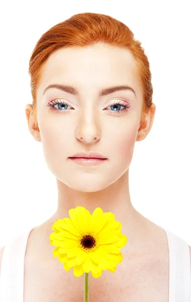 Woman with yellow flower near her face on white background — Stock Photo, Image