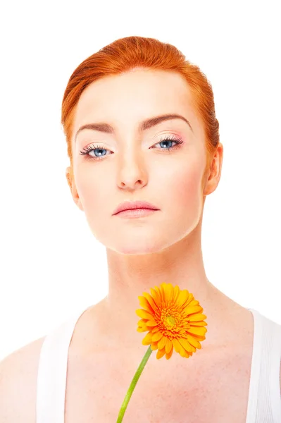 Woman with orange flower near her face on white background — Stock Photo, Image