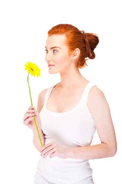 Woman with yellow flower near her face on white background — Stock Photo, Image