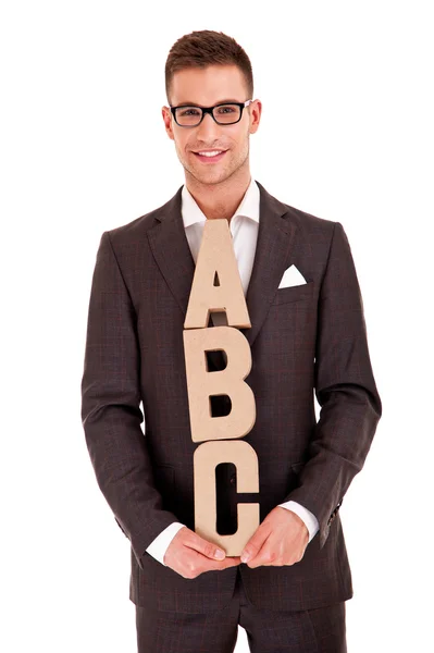 Joven guapo en traje clásico y con letras abc — Foto de Stock