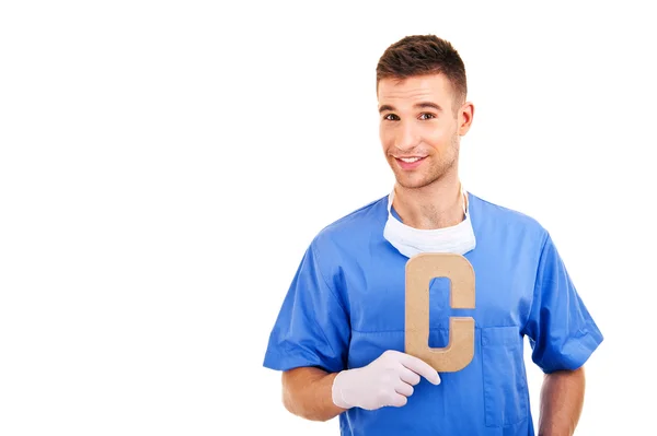 Young doctor holding letter c — Stock Photo, Image