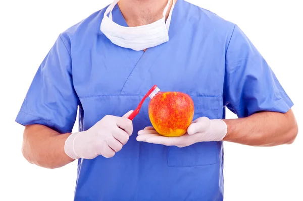 Cepillos de dientes y manzana en el fondo — Foto de Stock