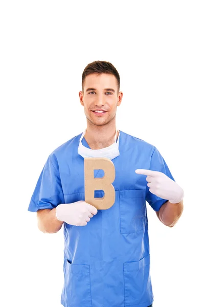 Young doctor holding letter b — Stock Photo, Image