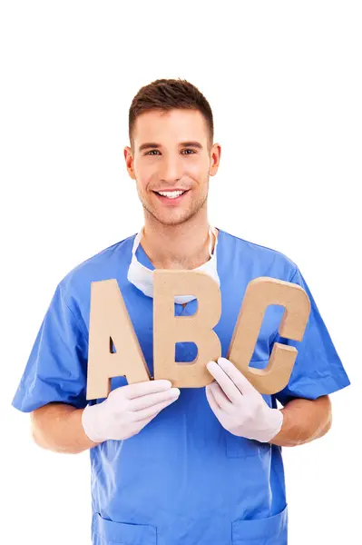 Young doctor holding letters a b c — Stock Photo, Image