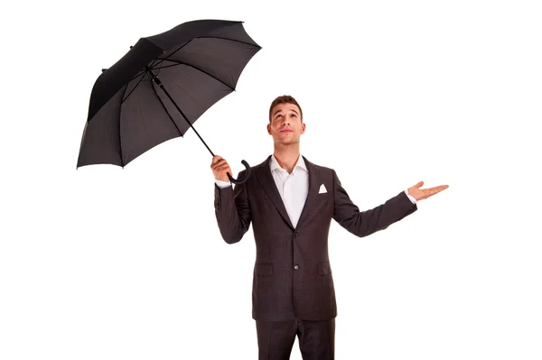 Jovem homem de negócios com um guarda-chuva verificando a chuva em — Fotografia de Stock