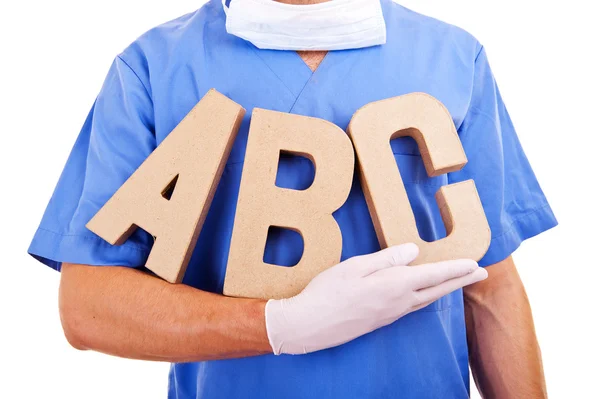 Young doctor holding letters a b c — Stock Photo, Image