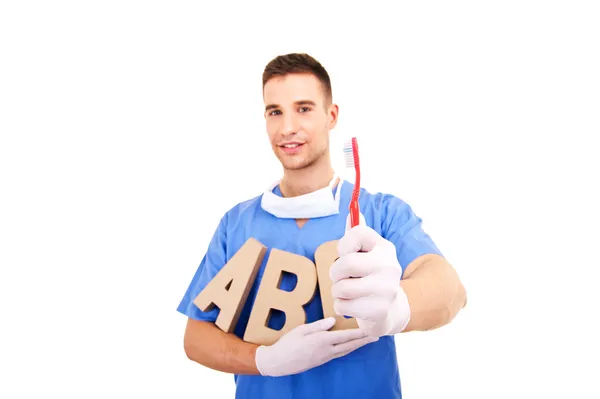 Dentist holding toothbrush — Stock Photo, Image