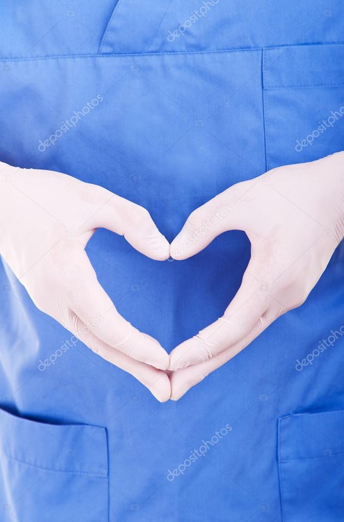 cardiologist in blue gloves take heart