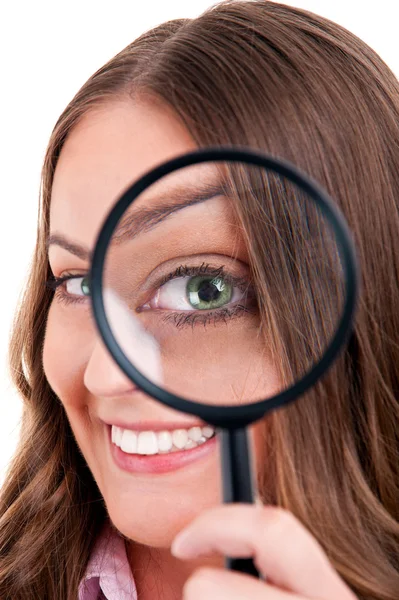 Beautiful woman looking through a magnifying glass Royalty Free Stock Photos