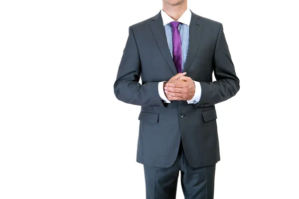 Businessman correcting a tie on black background — Stock Photo, Image