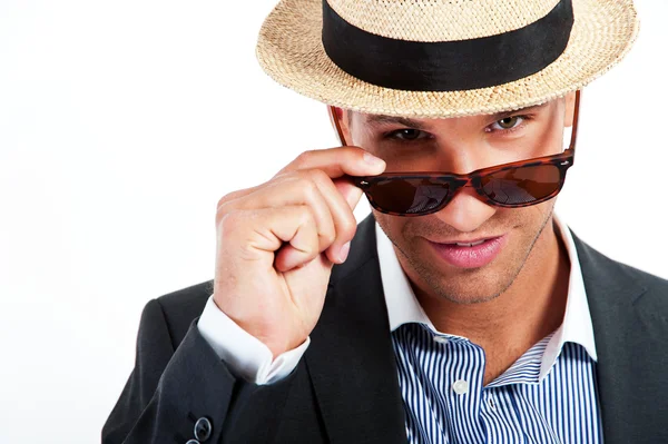 Fashion young man holding his fashionable sunglasses — Stock Photo, Image