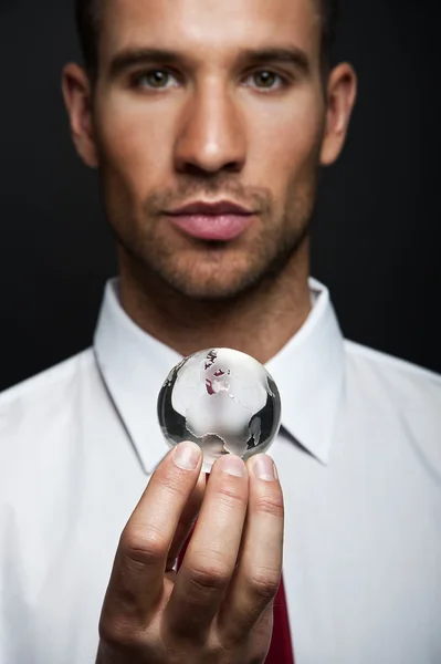 Businessman holds Earth in a hand — Stock Photo, Image