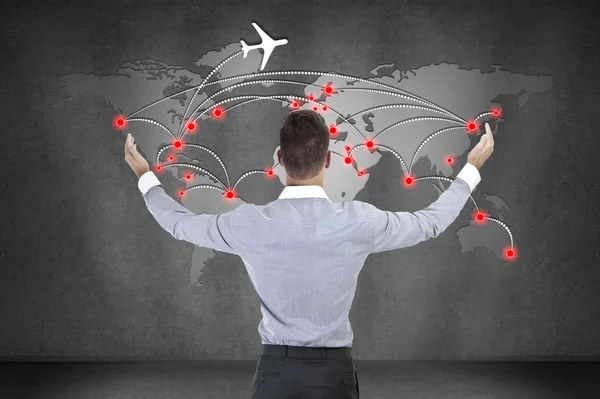 Businessman looking at scheme of international flights — Stock Photo, Image