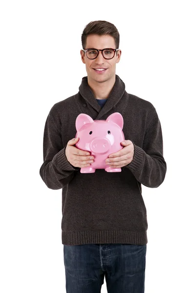 Man in sweater protect piggybank against white background — Stock Photo, Image