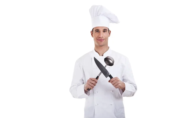 Chef. Isolated over white background. Holding knife and spoon — Stock Photo, Image