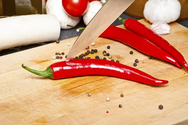Chili pepper on cutting board — Stock Photo, Image