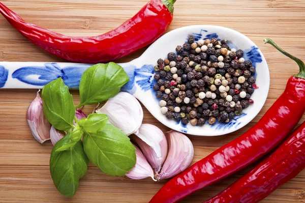 Spices on wooden spoons — Stock Photo, Image