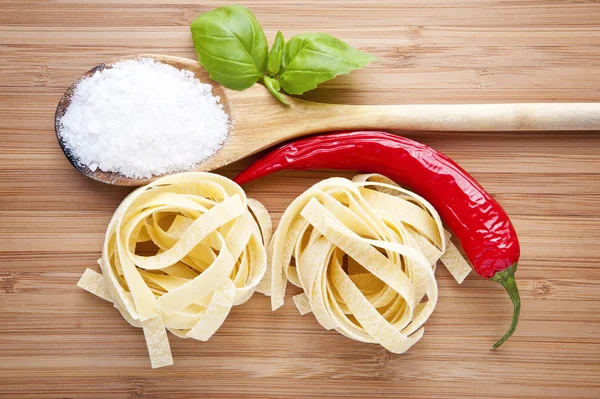 Noodles with paprika and spoon — Stock Photo, Image