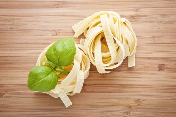 Pâtes italiennes fettuccine nid sur planche à découper — Photo