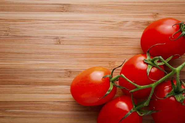 Fresh tomatoes on vintage wooden table — Stock Photo, Image